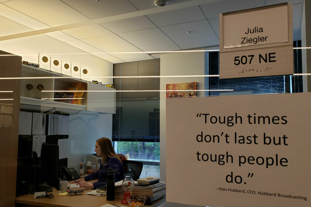 WTOP Director of News and Programming Julia Ziegler, seen here in her office participating in a conference call, comes into the office most days. Managers — Darci Marchese, Jared Ruderman and Pat Brogan — sometimes work at home and sometimes work in the office. Craig Schwalb, WTOP's new Director of Content Integration and Operations, has yet to meet the staff in person. He just moved here from the New York City area. For the first couple of weeks of his new job, Schwalb worked remotely, answering listener emails from what was jokingly known among the managers as the "Princeton Junction bureau." (WTOP/Matt Small)