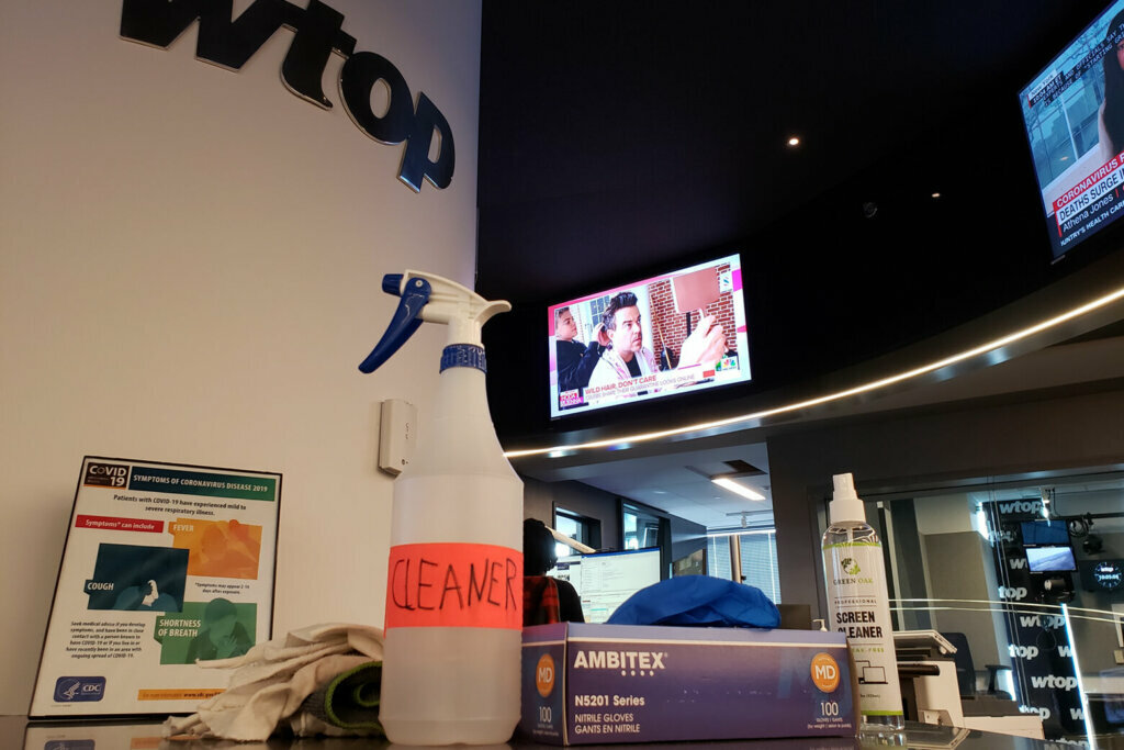 People still working in the WTOP newsroom clean their areas before and after each shift with what's been dubbed the "corona cleaner." (WTOP/Matt Small)