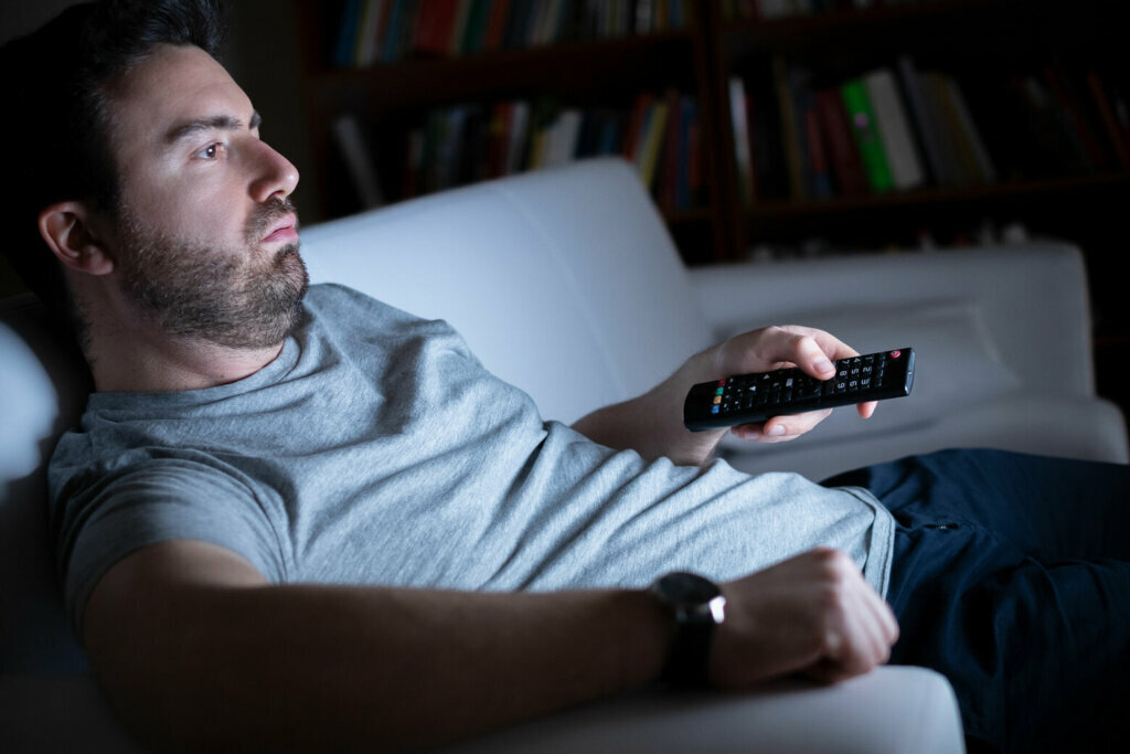 Portrait of one caucasian man watching tv