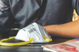 Closeup N95 air filter mask. personal protective equipment in office with soft focus and over light in the background