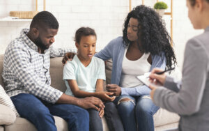 Little girl and her parents at psychologist consultation