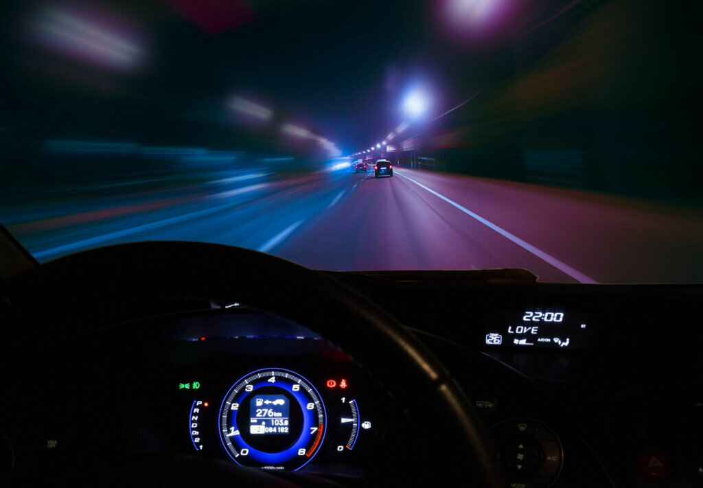 Car moving on highway at night