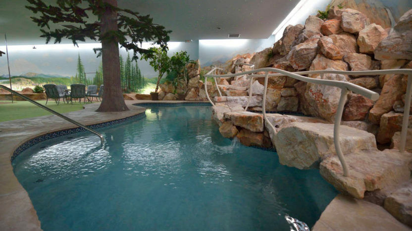 A waterfall is one of the features of this underground home. (Courtesy Berkshire Hathaway via <a href="https://www.toptenrealestatedeals.com/" target="_blank" rel="noopener noreferrer">TopTenRealEstateDeals.com</a>)