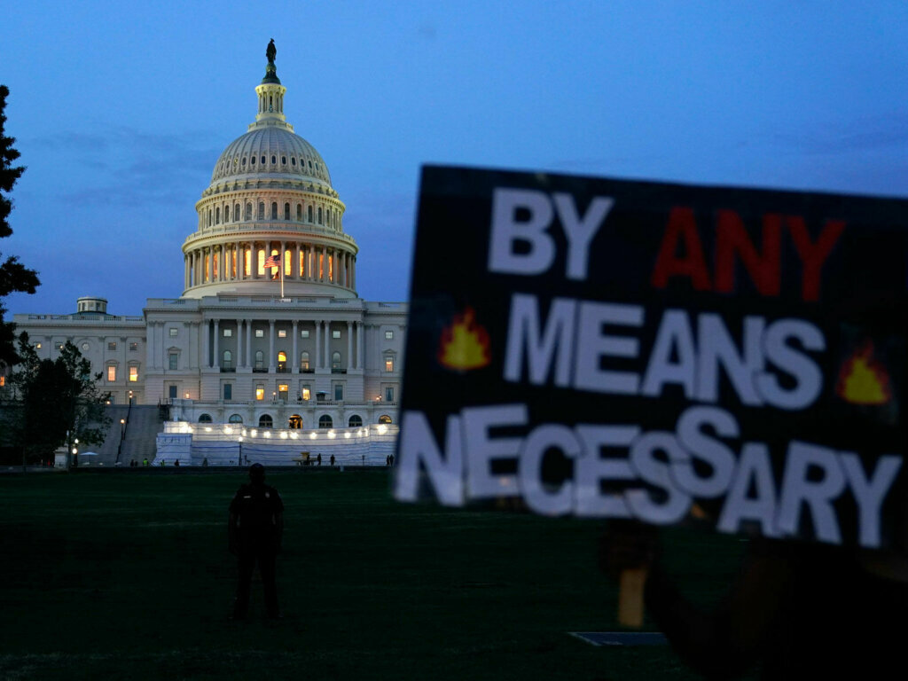 Demonstrators walk along Pennsylvania Avenue as they protest the death of George Floyd, a black man who died in police custody in Minneapolis, Friday, May 29, 2020, in Washington. (AP Photo/Evan Vucci)