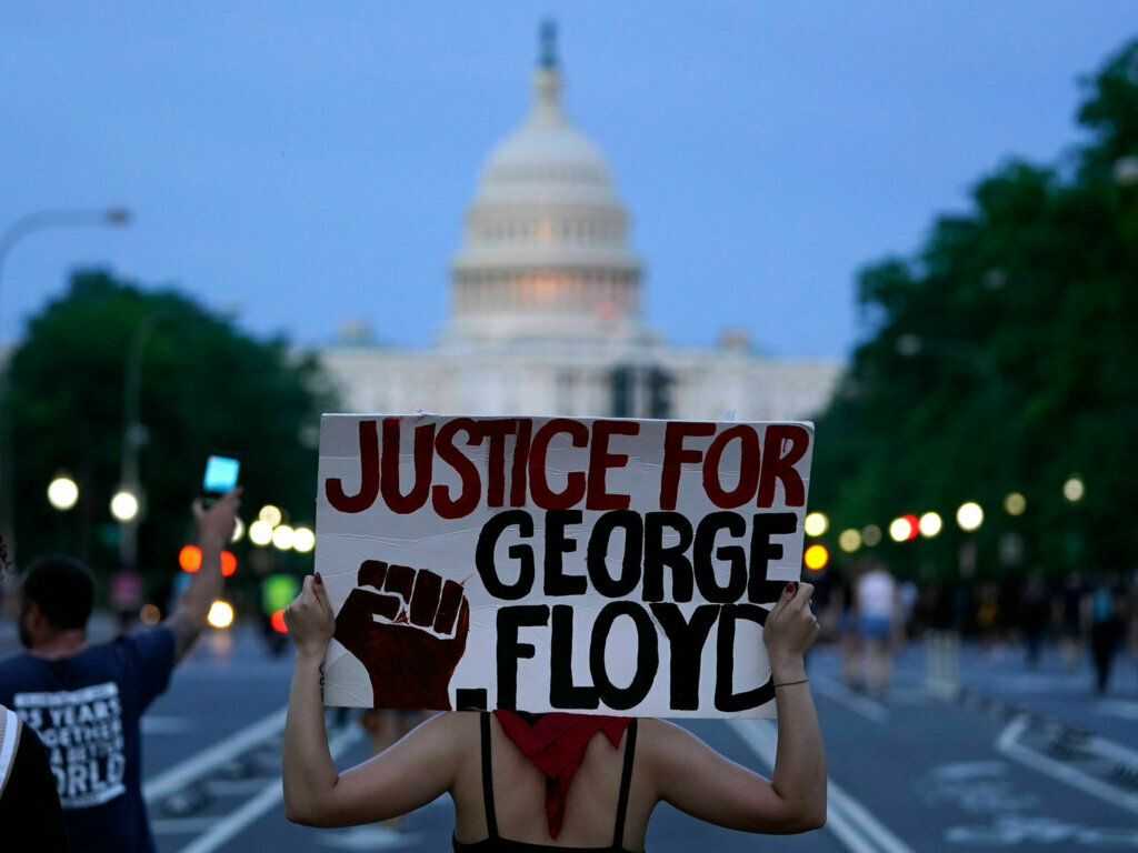 Demonstrators walk along Pennsylvania Avenue as they protest the death of George Floyd, a black man who died in police custody in Minneapolis, Friday, May 29, 2020, in Washington. (AP Photo/Evan Vucci)