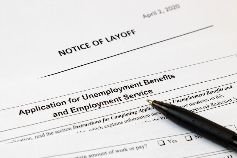 Job layoff notice and application for unemployment insurance benefits paperwork. Concept of Covid 19 coronavirus and stay at home order impact on economy