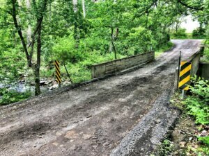 Unpaved, one lane bridge