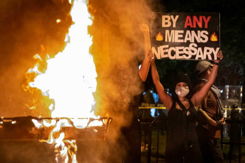 "We declare our right on this earth to be a man, to be a human being, to be respected as a human being, to be given the rights of a human being in this society, on this earth, in this day, which we intend to bring into existence by any means necessary." — Malcolm X, 1965. Pictured: A burning dumpster outside Lafayette Park on May 30. (WTOP/Alejandro Alvarez)