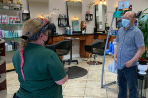 Heather Detrick speaks with an employee of a hair salon in Montgomery County, Maryland. (Courtesy Montgomery County Department of Housing and Community Affairs, Housing Code Enforcement)