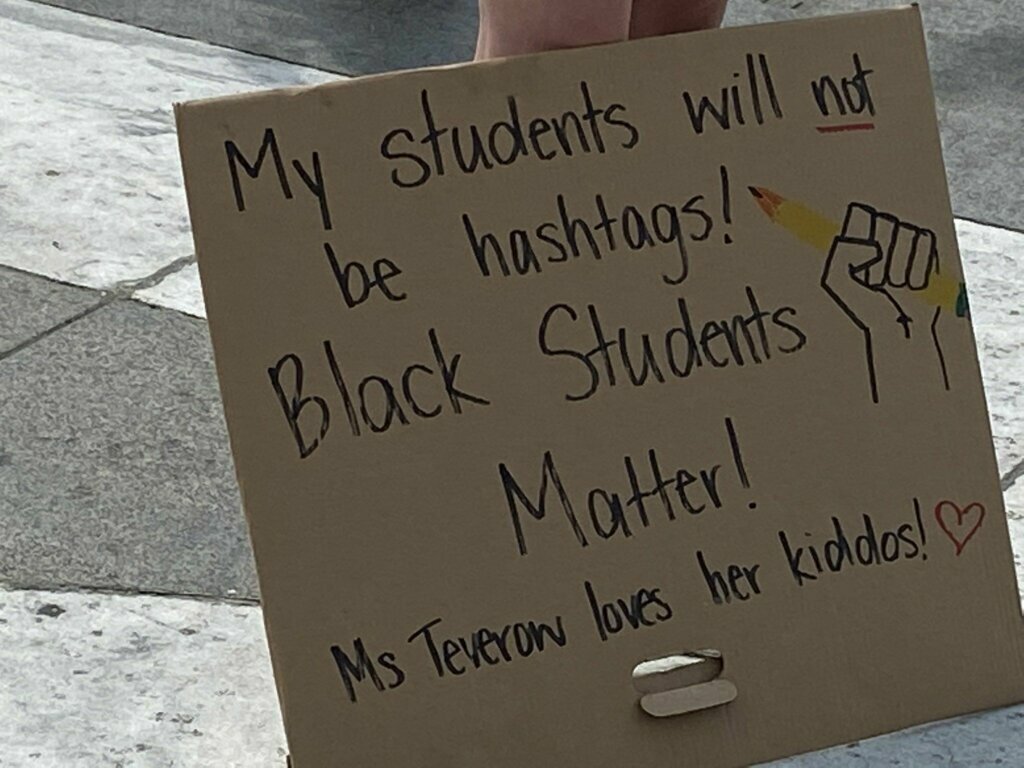 A teacher's sign in support of black students was part of the protests in D.C. during Juneteenth. (John Domen/WTOP)
