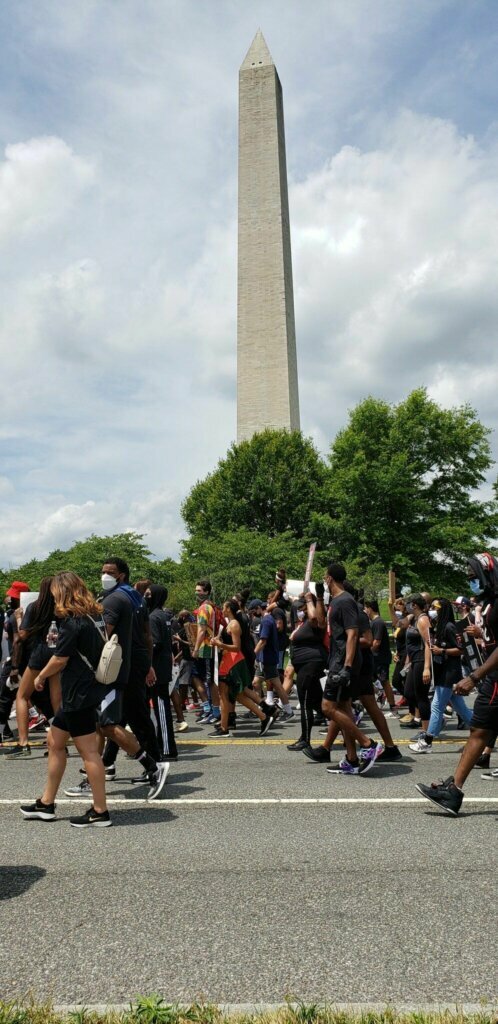 The march turns off of Constitution Avenue and heads down 15th street past the Washington Monument. (Dave Preston/WTOP)