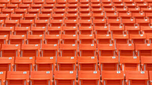 Stadium seat rows in sports arena for football or soccer game, public theatre, concert hall amphitheater with empty red audience chair for outdoor sporty recreational background