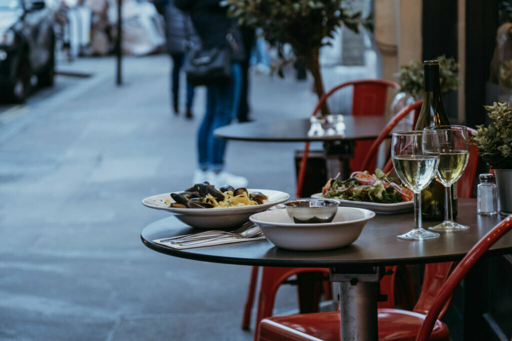 Food and wine on the outdoor table of a restaurant, selective focus.