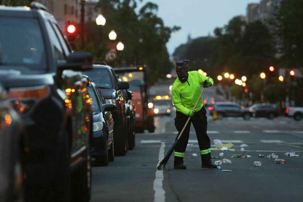 A member of a D.C. government cleaning crew cleans a street near the White House in the morning hours on June 2, 2020 in Washington, D.C.