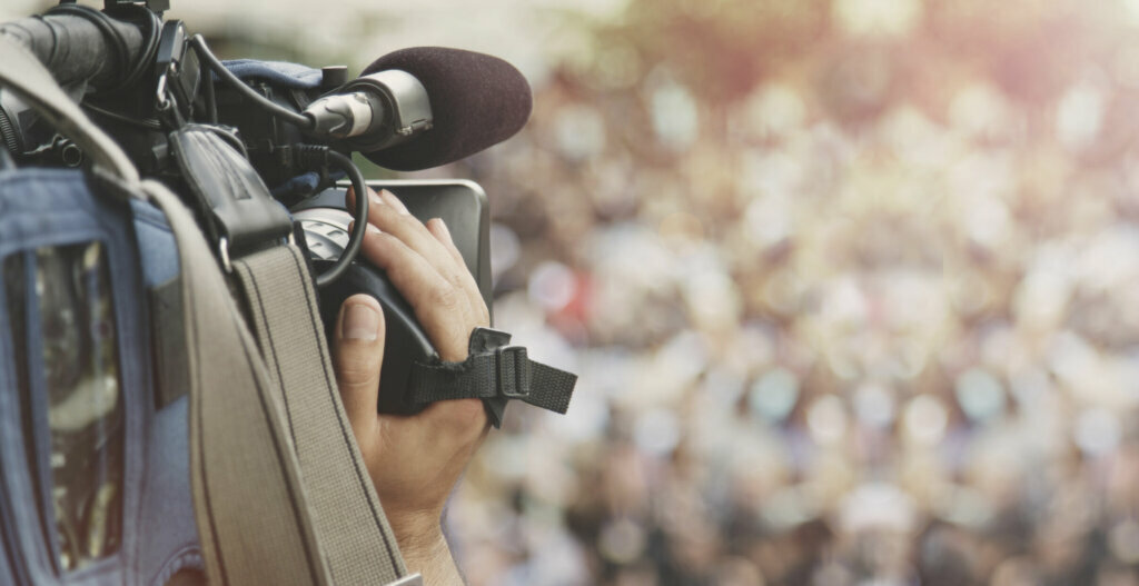 Cameraman shooting crowd