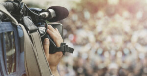 Cameraman shooting crowd