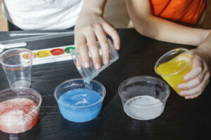 Children make experiments with paint and artificial snow