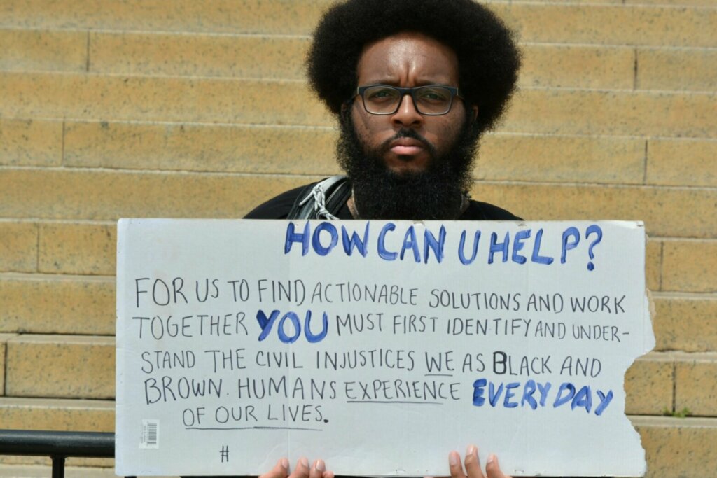 Roger Campbell II holds a sign during the protests in D.C. on Saturday, June 6, 2020. (WTOP/Monique Blyther)