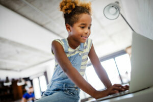 Game, study, fun concept. Happy children spending time with notebook and modern technology.