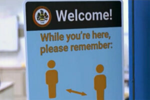 A sign encouraging social distancing is seen in a Fairfax County school. (CNN)