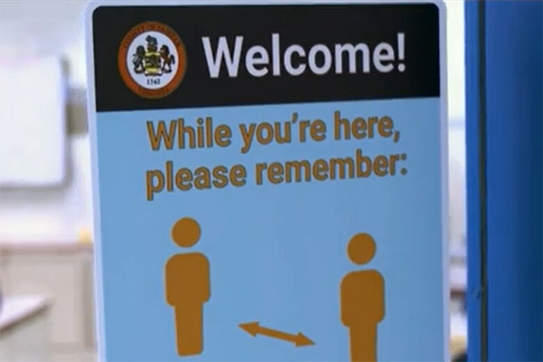 A sign encouraging social distancing is seen in a Fairfax County school. (CNN)