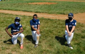3 kids kneeling baseball