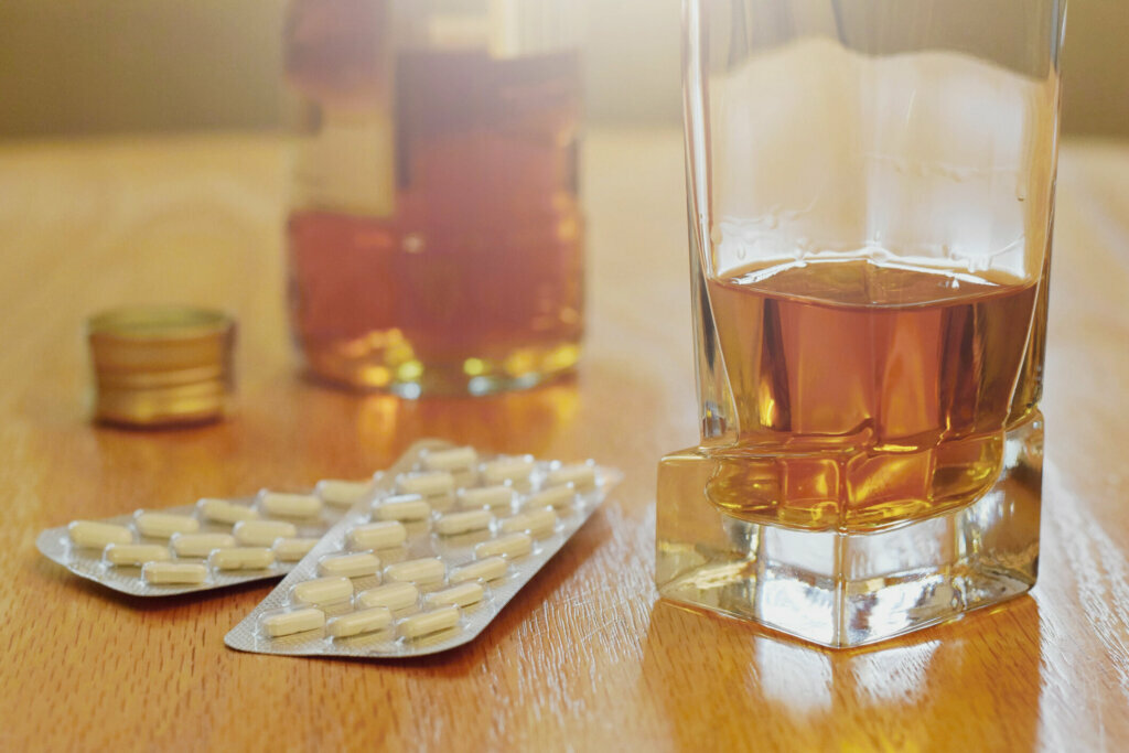 Pills and alcohol on the table, dependency concept