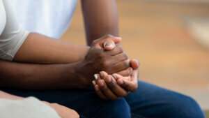 African american family couple holding hands, close up view