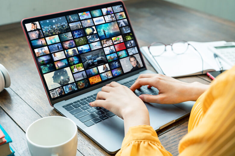 Young woman using a laptop computer. Graphic designer. UX design.
