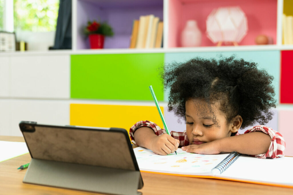 Young Black girl virtually learning.