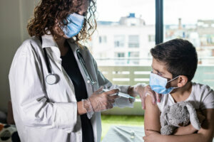 Little boy getting vaccinated from Covid