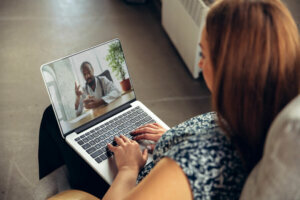 Close up of young woman getting online medical help and advice during videocall with doctor checking symtoms aand explaining the drug's reciepes
