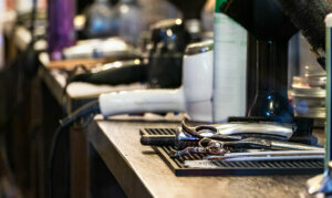 Hairdresser tools on a desk, no people. Barber shop closed during pandemic lockdown