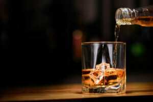 Still life. pour or whiskey in to glass