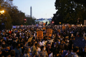 People celebrate in the streets outside the White House