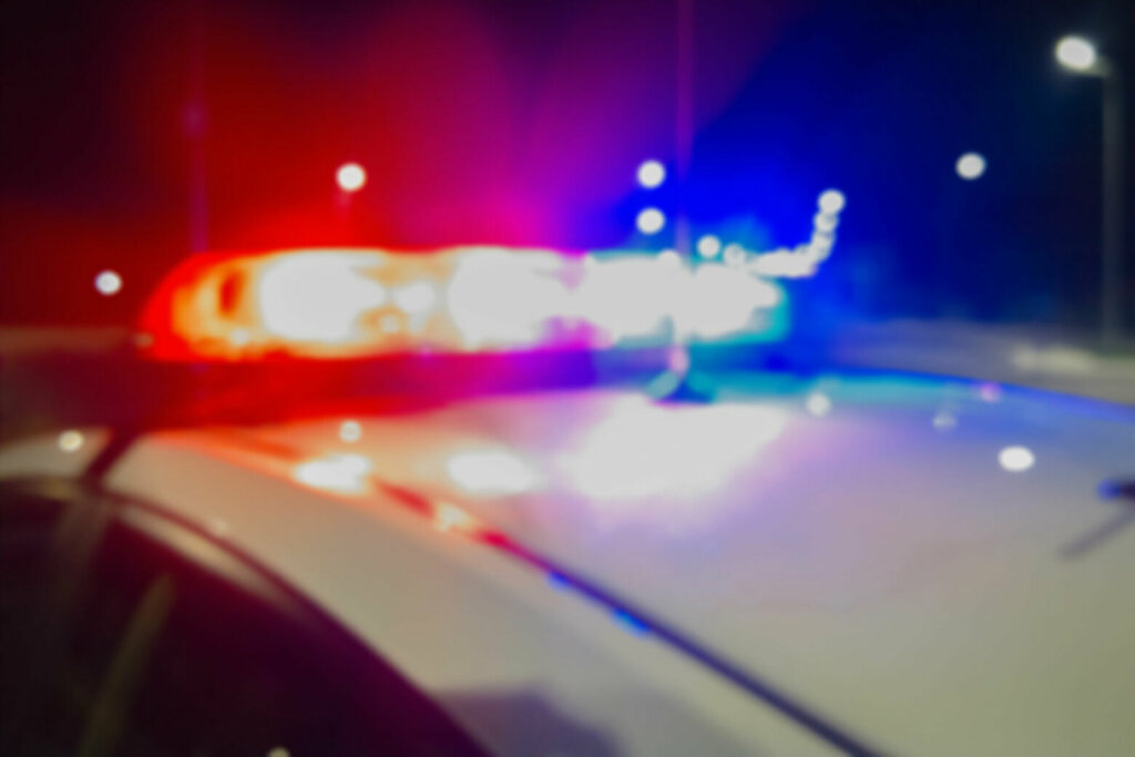 Red and blue Lights of police car in night time. Night patrolling the city. Abstract blurry image.