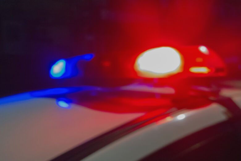 Red and blue Lights of police car in night time. Night patrolling the city. Abstract blurry image.