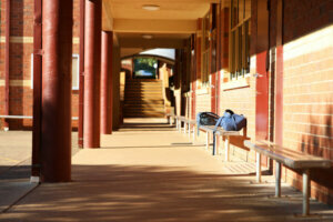 Exterior buildings outside a classroom in a school environment. School bags on a seat chair