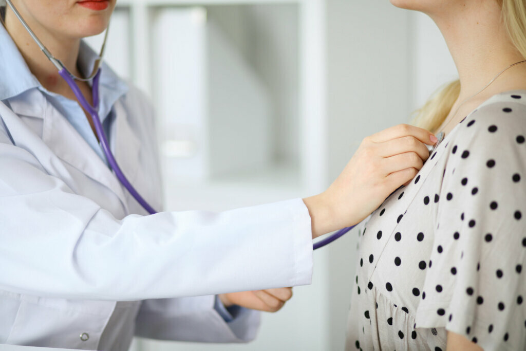 Doctor examines a patient with a stethoscope