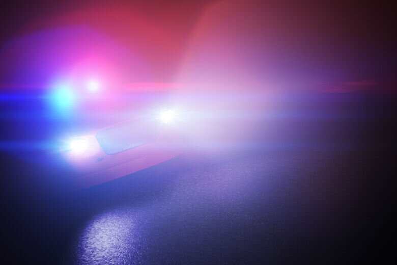 Police car with emergency siren at night