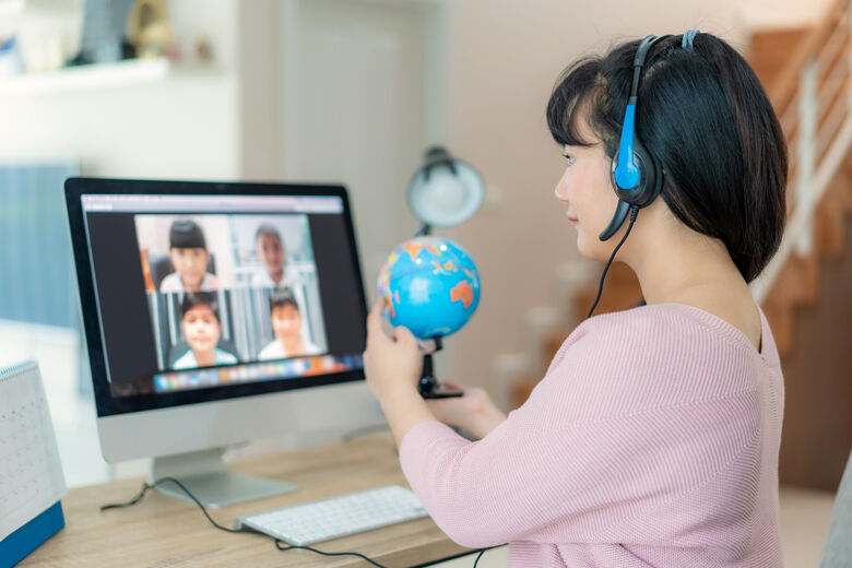 Asian woman teacher teaching geography via video conference e learning and cheerful elementary school student looking at globe, Homeschooling and distance learning ,online ,education and internet.