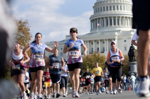Runners pass the U.S. Capitol Building on Capitol Hill