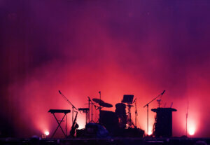 Concert stage on rock festival, music instruments silhouettes