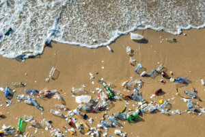 Waves pushing plastic waste to the beach