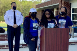 Cheryl LouAllen, mother of Jahmar Latravern Graves, speaks during a briefing Tuesday. Prince William County Police Chief Peter Newsham stands on the left. (WTOP/Neal Augenstein)