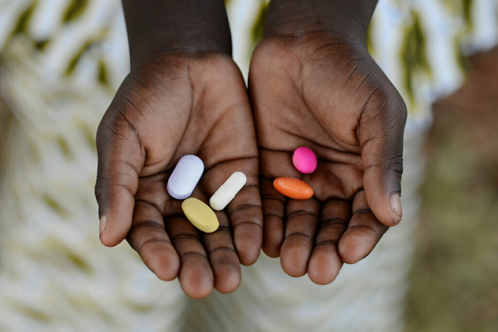 Healthy Lifestyle Medicine African Black Boy Holding Colorful Pills Background