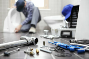 Plumber at work in a bathroom, plumbing repair service, assemble and install concept