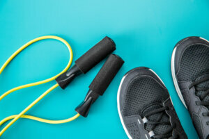 Black sport shoes and jump rope.