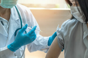 Immunization and vaccination for flu shot, influenza, HPV or Covid 19 prevention with young child girl having vaccine injection for World immunization week and International HPV awareness day