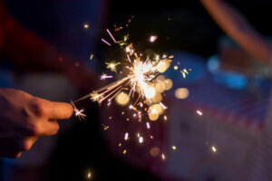 Lighting sparklers in the backyard on a summer evening